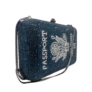 Detailed side view of luxury navy crystal passport clutch with silver chain strap