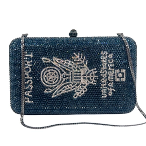 Detailed view of the dark blue crystal passport clutch with intricate eagle emblem