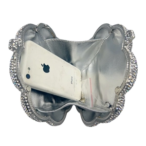 Elegant silver rose rhinestone clutch bag with scalloped edges and chain strap shown with phone