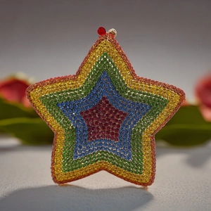Macro detail of star-shaped clutch bag with rainbow gradient rhinestones and top metal clasp