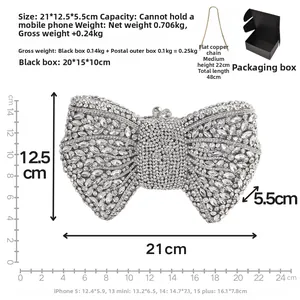Detailed view of silver bow clutch bag with rhinestones, chain strap and gift box