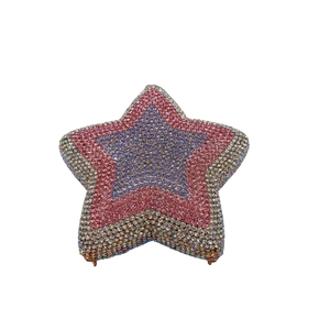 Detail of star-shaped clutch bag featuring multi-color rhinestone layers and metal hinge
