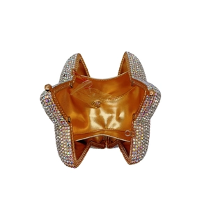 Star-shaped crystal clutch showing gold satin lining and metal frame interior detail