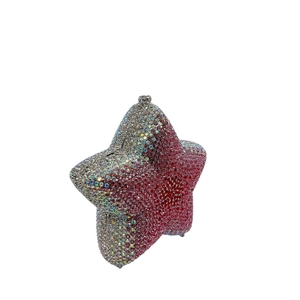 Close-up of star shaped clutch bag with gradient rhinestones from silver to deep red