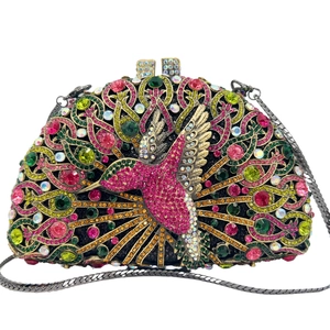 Detail of luxury bird clutch bag with colorful crystals and floral metal patterns