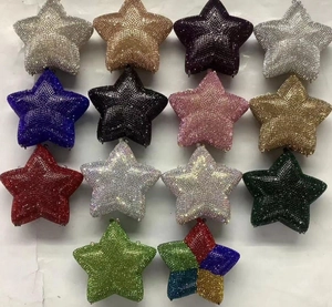 Detailed view of star-shaped crystal evening clutch bags in multiple vibrant colors