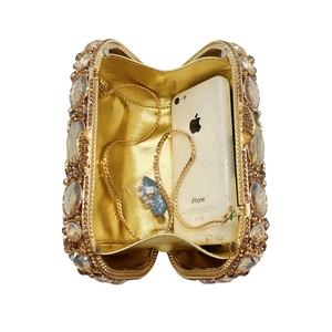 Luxurious gold evening clutch bag encrusted with champagne crystals and rhinestones