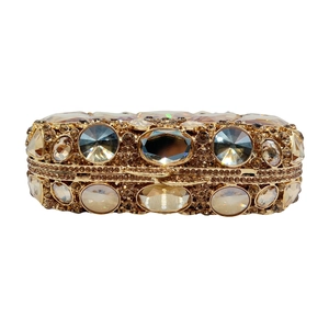 Detail of luxury champagne gold clutch with hand-set crystals and rhinestones