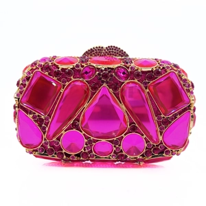Detail of rose red stone clutch bag with oversized crystals and metallic top closure