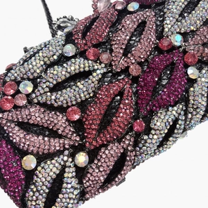 Macro detail of luxury lip shaped clutch bag with pink crystals and metallic shell