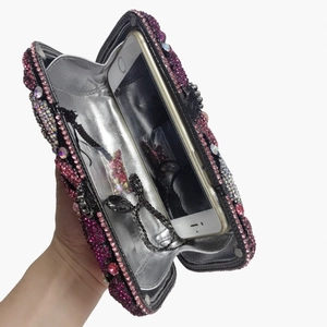 Pink rhinestone clutch interior view showing spacious capacity for smartphones and items