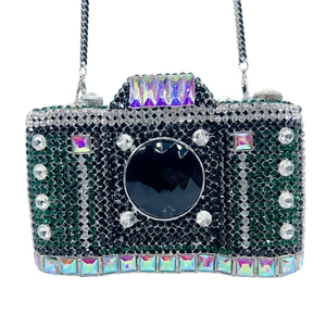 Detail of camera-shaped evening clutch with green and black crystals and chain strap