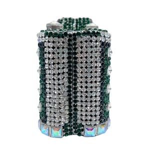 Detailed macro of green and silver rhinestones with iridescent gems on luxury clutch