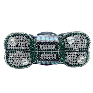 Detailed view of luxury camera-shaped clutch bag with emerald and white rhinestones