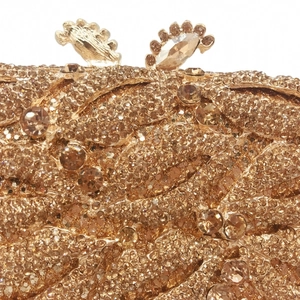 Champagne gold crystal evening clutch bag with intricate wavy rhinestone texture