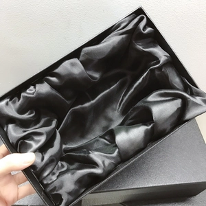 Detailed view of an elegant black gift box with a soft luxury satin lining