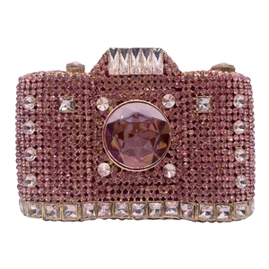 Macro shot of camera-shaped luxury pink rhinestone clutch with crystal lens detail
