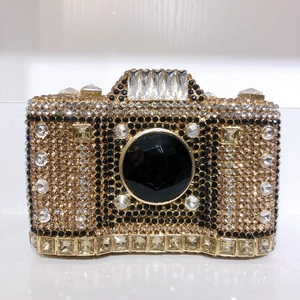 Detailed view of luxury camera-shaped clutch bag with sparkling rhinestone embellishments