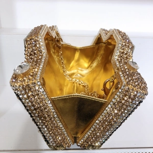 Internal view of star-shaped evening clutch with gold metal lining and chain strap