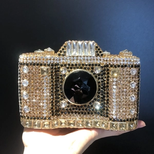Detailed view of luxury camera-shaped clutch bag with sparkling crystals and gems