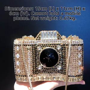 Detail of camera-shaped evening clutch with gold rhinestones and 15x11x6cm size info