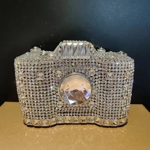 Macro shot of silver rhinestone camera clutch bag with sparkling lens detailing