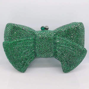 Macro shot of emerald green crystal evening bag featuring a radiant bow-knot shape design
