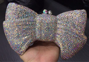 Detailed view of luxury bow-shaped evening clutch with iridescent crystal rhinestones