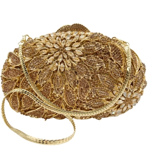 Detailed close-up of golden leaf floral evening bag with sparkling diamond crystals