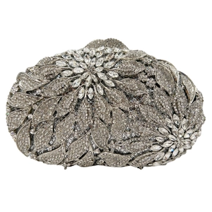 Close-up of silver crystal evening clutch featuring intricate leaf and floral stone patterns