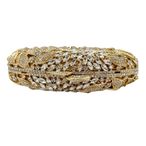 Detail of gold floral leaf pattern clutch bag encrusted with sparkling rhinestones