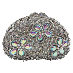 Detailed close-up of sparkling floral rhinestones on a silver metal evening clutch bag