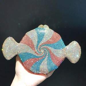 Detailed view of candy-shaped clutch with pink and blue rhinestones in spiral pattern