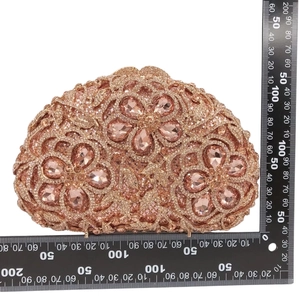 Detail of pink rhinestone evening bag with flower gems and measurement scale