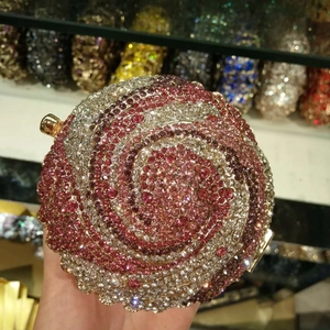Spherical evening clutch bag with pink and white crystal spiral pattern and gold frame