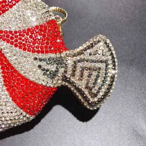 Macro shot of sparkling fish-shaped clutch with red and white crystal embellishments