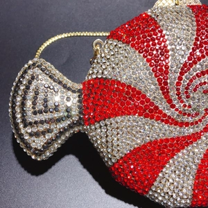 Macro detail of candy-shaped clutch bag with luxury rhinestones and gold chain strap