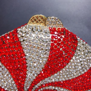Macro shot of candy clutch bag with red and white rhinestones and a gold metal clasp
