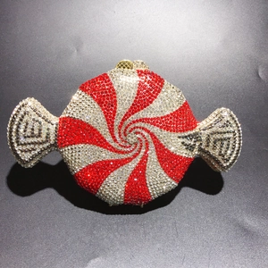 Macro detail of a candy-shaped clutch bag featuring red and white rhinestones decoration