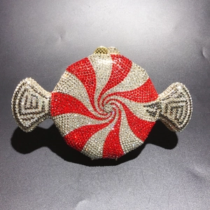 Detail of candy-shaped clutch bag with sparkling rhinestone swirl and heart-shaped clasp