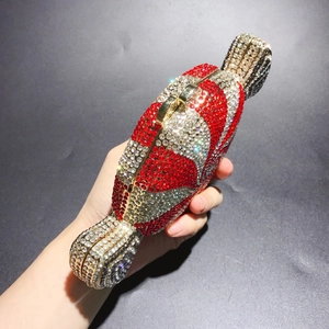 Macro detail of luxury candy clutch bag with red and white rhinestones and gold clasp