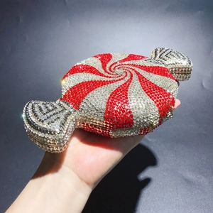 Handheld candy-shaped clutch bag featuring red and silver spiraled rhinestone detailing