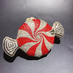 Macro shot of candy-shaped clutch bag featuring red and silver rhinestone spiral stripes