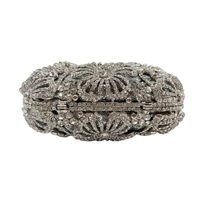Detailed view of silver crystal clutch bag with intricate floral rhinestone pattern