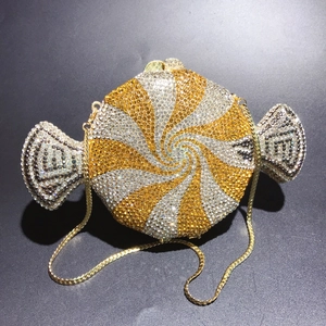Macro detail of candy-shaped evening clutch with sparkling gold and silver rhinestones