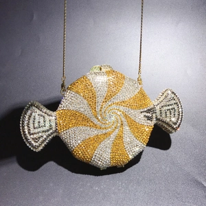 Detailed view of candy-shaped luxury evening clutch with yellow and white rhinestones