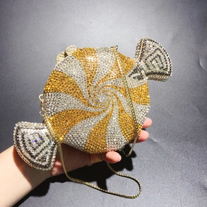 Detailed view of candy-shaped evening clutch bag with sparkling rhinestones and chain strap
