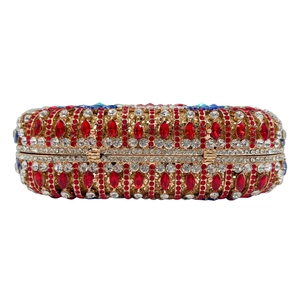 Elegant gold frame clutch bag with red and white rhinestones and blue gem accents