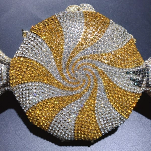Close-up of candy-shaped evening clutch with sparkling gold and silver rhinestones