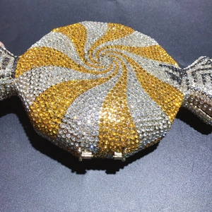 Close-up of candy-shaped clutch with yellow rhinestones and spiral crystal pattern